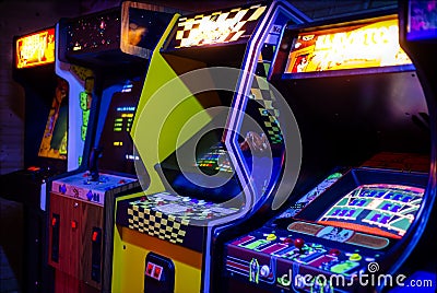 Row of Old Arcade Video Games with Shining Displays Editorial Stock Photo