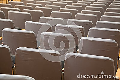 Row of old grey seats in cinema Stock Photo