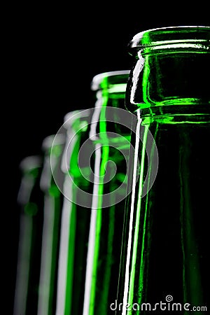 Row of open green beer bottles Stock Photo