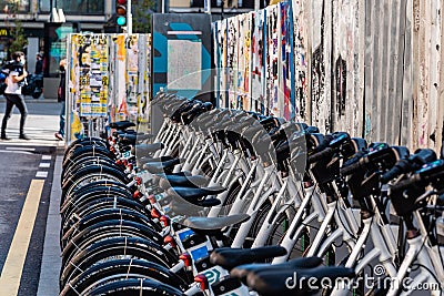 Row of parked electric rental bicycles in MAdrid Editorial Stock Photo