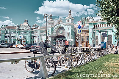 A row of parked rental bikes on Tverskaya Zastava Square in front of Belorussky Railway Station Editorial Stock Photo