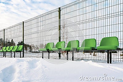 The row of plastic green seats at sports stadium Stock Photo