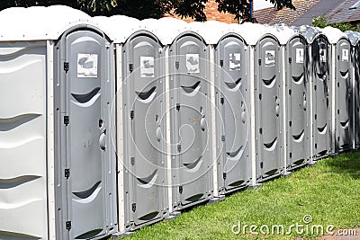 Row of portable outside toilets. Stock Photo