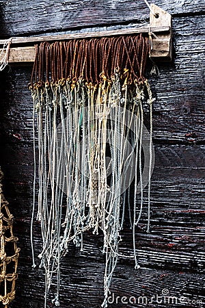 Rusty Big Game Fish Hooks Hanging With Rope Tied Stock Photo
