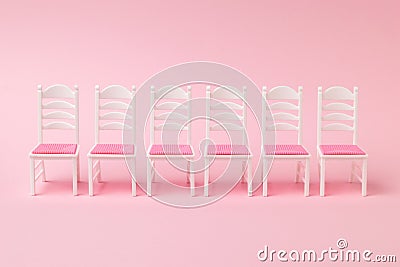 A row of six chairs on a pink background Stock Photo