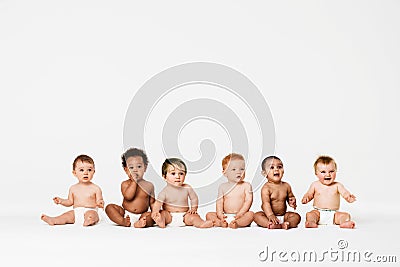 Row of six multi ethnic Babies smiling in studio Stock Photo