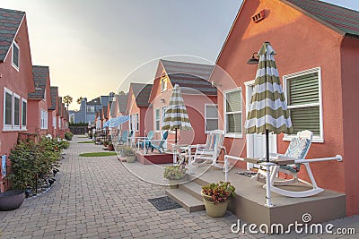 Row of small cabins with coral pallette exterior at Oceanside, California Stock Photo