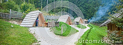 Row of small wooden cabins at Hija Glamping Lake Bloke in Nova Vas, Slovenia Stock Photo