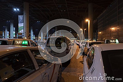 Row of Spanish cabs parked in the cab parking at Atocha train station in Madrid Editorial Stock Photo