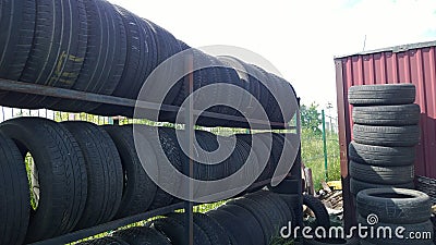 Row and stack of old used car tires. Pile of rubbish. Recycling worn tyre and wheel. Environmental issues. Climate crisis and Stock Photo