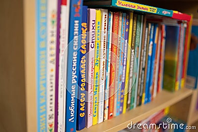 Row of stacked Russian kid books on a shelf. Editorial Stock Photo