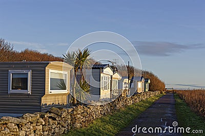 A row of static Caravans in Wairds Park facing the Beach in the Fishing Village of Johnshaven Editorial Stock Photo