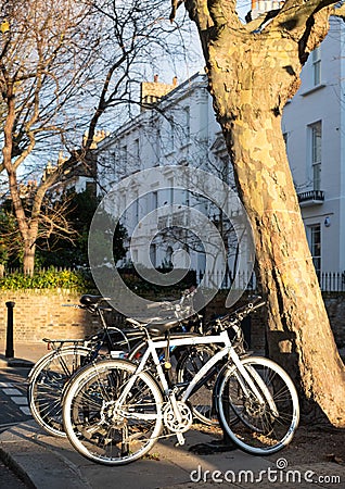 Row of terraced houses in Primrose Hill, London UK. Photographed on a cold, bright winter`s day with bicycles in foreground. Stock Photo