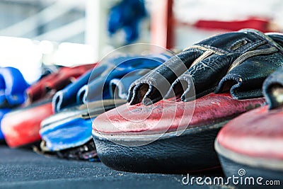 Row of thai Boxing Mitt Training Target Focus Punch Pad Glove on Stock Photo