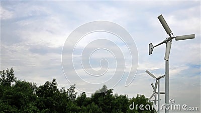 A Row of Three Blades Wind Turbines Stock Photo