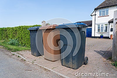 Row of three wheelie bins outside a house. UK Editorial Stock Photo