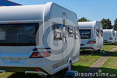 A row of touring caravans on standing on a sunny day in summer Stock Photo