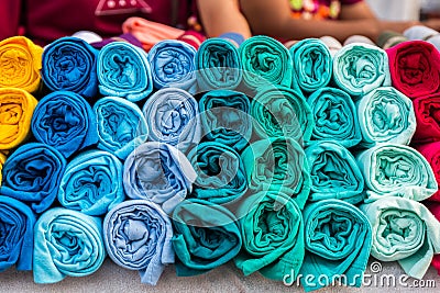 Row of variety multicolored shirt clothes hanging on shelf outdo Stock Photo