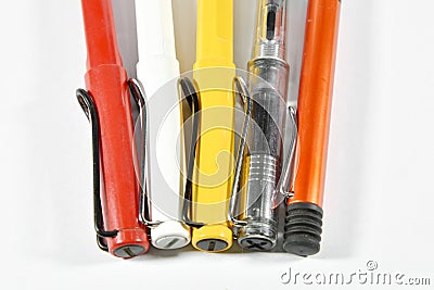 Row of various multicolored pens Stock Photo