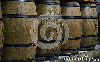 A row of vertical hooped wooden barrels Stock Photo
