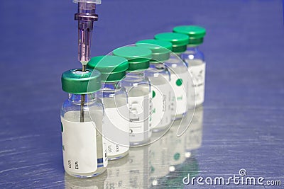 Row of vials and needle Stock Photo