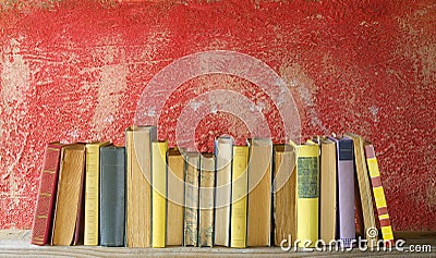 Row of vintage books on red background Stock Photo