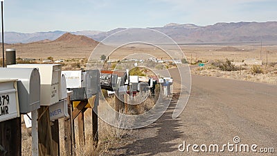 Row of vintage drop boxes on road intersection, arid Arisona desert, USA. Postal retro mailboxes on roadside of tourist Route 66. Editorial Stock Photo