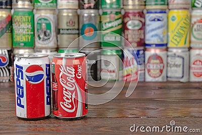 A row of vintage Pepsi, Coca-Cola aluminium cans with the cans background located on the wooden table Editorial Stock Photo