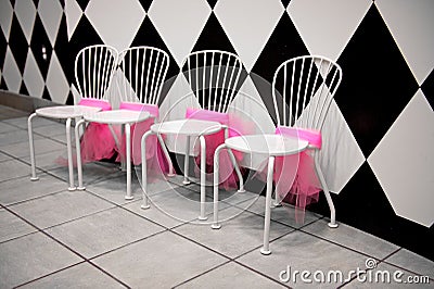 Row of White Chairs with Pink Ribbons Stock Photo