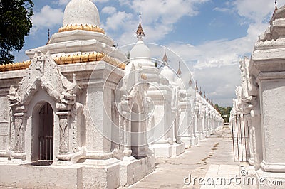 Row of white pagodas in Maha Lokamarazein Kuthodaw Pagoda in My Stock Photo