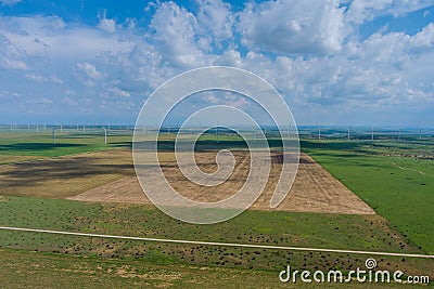 Row of windmill renewable energy turbines on a wind farm in the Texas Stock Photo