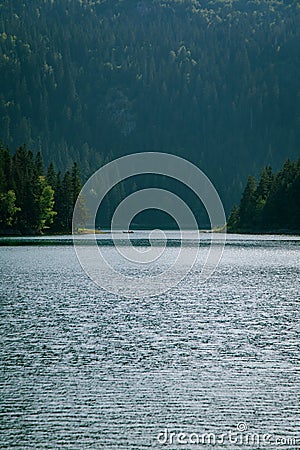 Rowboat isolated in the mysterious and majestic Black Lake, Durmitor National Park, Zabljak, Montenegro. Stock Photo