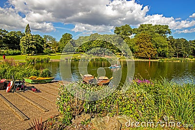 Rowboats docked in small lake at park in Birmingham, England Stock Photo