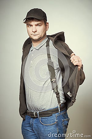 Rowdy bad man in black hooded shirt and black hat armed with dagger Stock Photo