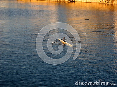 Rower on the river at sunset Stock Photo