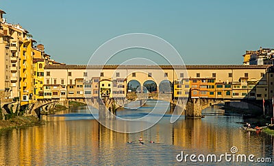 Rowers out on the River Arno during a lovely sunny morning in Florence, Italy, with the historic Ponte Vecchio in the background Stock Photo