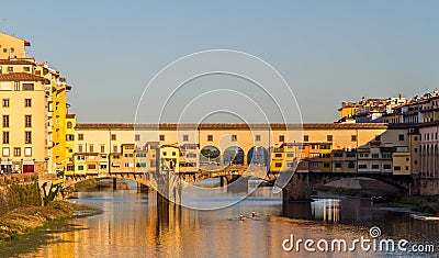 Rowers out on the River Arno during a lovely sunny morning in Florence, Italy, with the historic Ponte Vecchio in the background Stock Photo