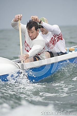 Rowers Paddling Outrigger Canoe Stock Photo