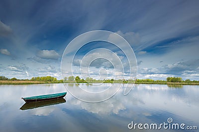 Rowing boat floating on a small lake in The Ooijpolder by Nijmegen, Holland. Stock Photo