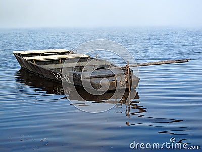 Rowing boat in morning fog on the lake Stock Photo