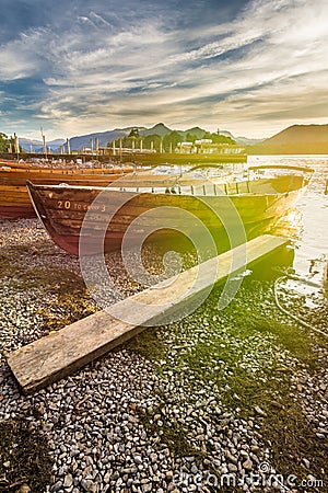 Rowing Boats At Keswick Boat Landings With Sun Flare Lens Distortions. Stock Photo