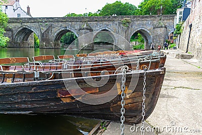 Rowing boats lined up on the Wear river in the city centre of Durham Editorial Stock Photo