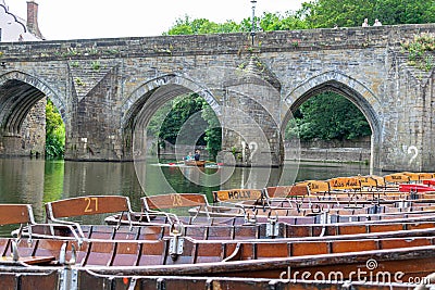 Rowing boats lined up on the Wear river in the city centre of Durham Editorial Stock Photo