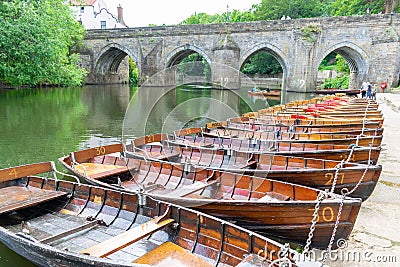 Rowing boats lined up on the Wear river in the city centre of Durham Editorial Stock Photo