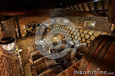 Rows of alcoholic drums in stock. Distillery. Cognac, whiskey, wine, brandy. Alcohol in barrels Stock Photo