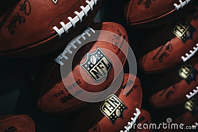 Rows of american football balls in NFL Experience in Times Square, New York Editorial Stock Photo