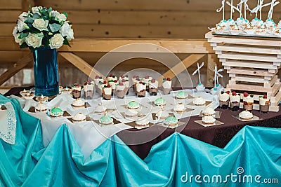 Rows of birthday cupcake with butter white and blue cream icing on a wooden stand Stock Photo