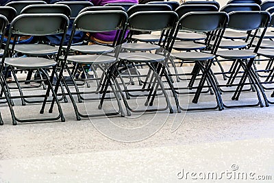 Rows of black folding chairs empty Stock Photo