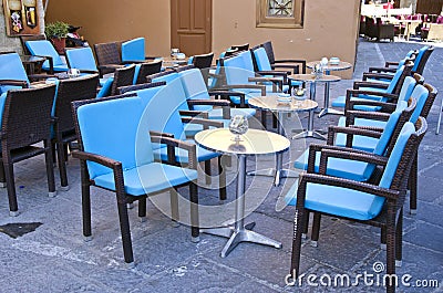 Rows of blue chairs and metallic tables in caffe Stock Photo