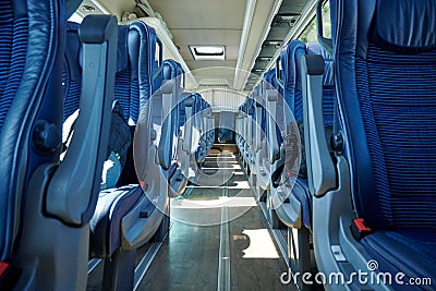 Rows of blue and gray seats in the public transport. Stock Photo